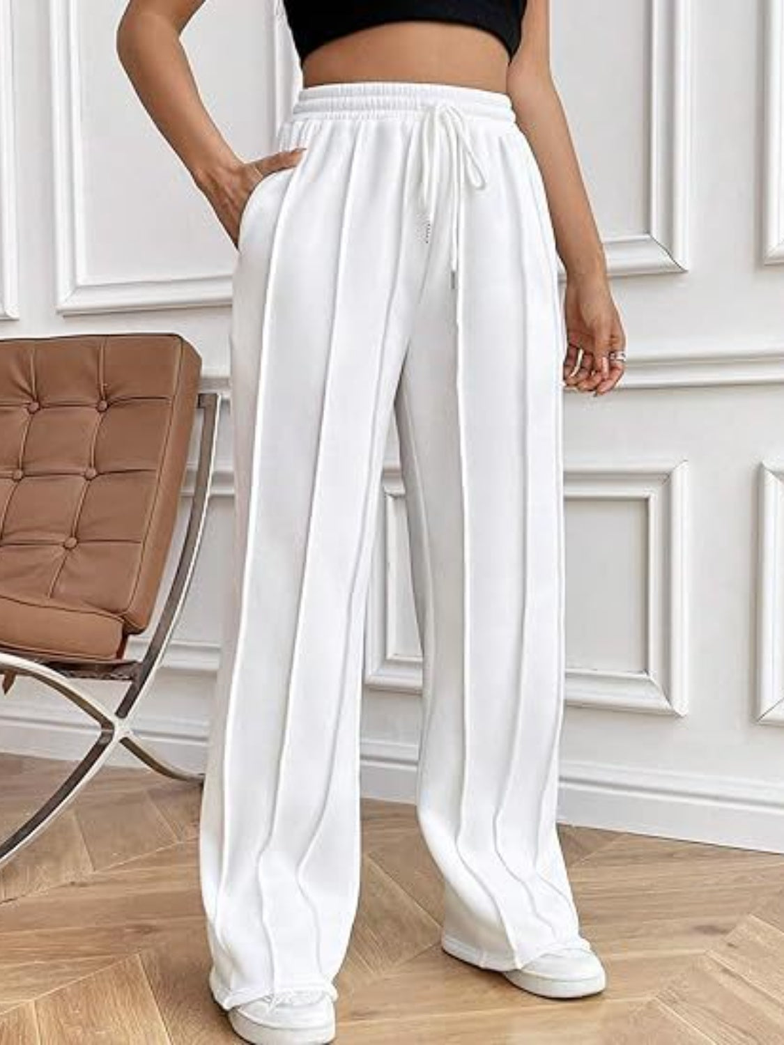 These expertly crafted wide leg pants offer both style and practicality, with a drawstring waistband and spacious pockets. Experience ultimate comfort and convenience in the perfect addition to any wardrobe.