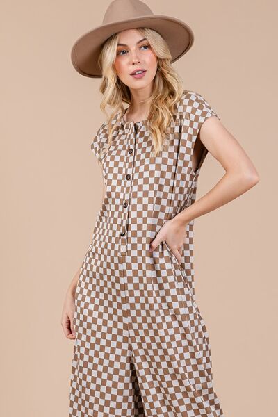 Unleash your bold and adventurous side with our Checkered Half Button Cap Sleeve Jumpsuit! This stylish jumpsuit combines checkered print, cap sleeves, and a half button design for a unique and daring look. Perfect for those who love to take risks and stand out from the crowd. Make a statement with this jumpsuit!