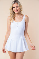 Elevate your summer style with our White Birch Sleeveless Performance Knit Swim Dress! The built-in shorts and bra pads provide coverage and support, while side slits add a touch of flair. Crafted from lightweight performance knit fabric, this dress offers both practicality and comfort for a day by the water. Embrace the season with confidence and elegance.