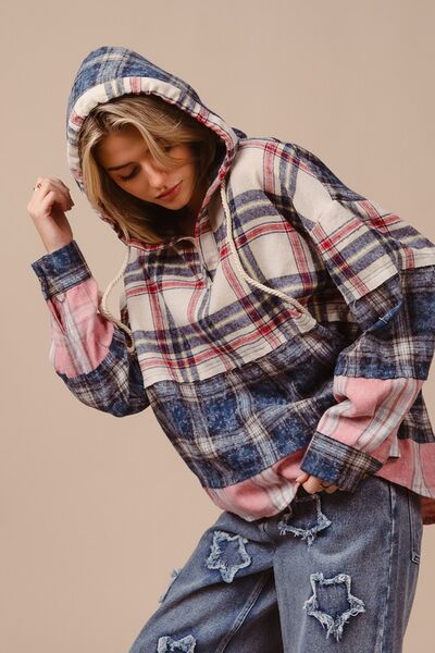 Be bold and fashionable in the Drop Shoulder Plaid Hoodie with Drawstring! The trendy plaid design adds an edgy touch, while the relaxed fit provided by the drop shoulders allows for comfort and style. Stay warm and customize the hoodie with drawstring detailing. Make a statement on cooler days with this functional yet trendy piece.