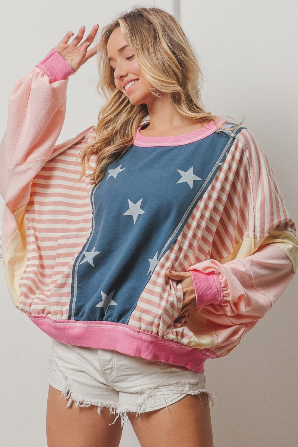 Tap into your daring side with our Cruisin Essentials Stars and Stripes Round Neck Long Sleeve Top. Add a bold and stylish touch to your wardrobe with this versatile piece, ideal for creating inspiring and challenging outfits. Classic round neckline and playful stars and stripes design make a statement when paired with go-to jeans or leggings. Dare to be different with this must-have top!