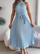 Indulge in luxury with our Grecian Neck Tie Waist Pleated Dress. Its elegant design features a Grecian-inspired neckline, chic neck tie, and flattering tied waist. The pleated skirt adds a touch of femininity, making it perfect for any special occasion. Elevate your wardrobe with this exclusive piece.