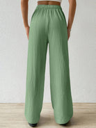 Effortlessly chic and comfortable, our Sage-colored Drawstring Wide Leg Pants are perfect for any occasion. The drawstring waist allows for a customizable fit, while the wide leg design provides freedom of movement. Made with high-quality materials, these pants are a must-have in your wardrobe.