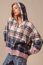 Be bold and fashionable in the Drop Shoulder Plaid Hoodie with Drawstring! The trendy plaid design adds an edgy touch, while the relaxed fit provided by the drop shoulders allows for comfort and style. Stay warm and customize the hoodie with drawstring detailing. Make a statement on cooler days with this functional yet trendy piece.