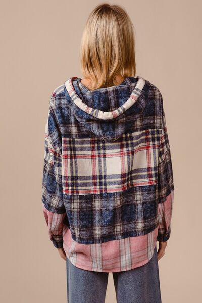 Be bold and fashionable in the Drop Shoulder Plaid Hoodie with Drawstring! The trendy plaid design adds an edgy touch, while the relaxed fit provided by the drop shoulders allows for comfort and style. Stay warm and customize the hoodie with drawstring detailing. Make a statement on cooler days with this functional yet trendy piece.