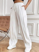 Elevate your wardrobe with our expertly crafted Wide Leg Pants. The drawstring waistband and spacious pockets offer practicality, while the design exudes style. Enjoy ultimate comfort while staying on-trend. A must-have addition to your wardrobe.