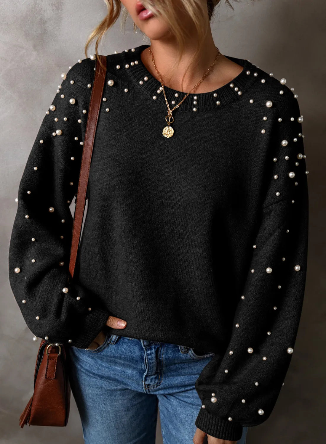 Elevate your style with our Cruisin Essentials Sweater! Adorned with elegant pearls on the round neck and sleeves, this cozy sweater adds sophistication to any look. Dare to be bold and stand out from the crowd with this statement piece.