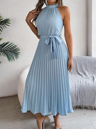 Indulge in luxury with our Grecian Neck Tie Waist Pleated Dress. Its elegant design features a Grecian-inspired neckline, chic neck tie, and flattering tied waist. The pleated skirt adds a touch of femininity, making it perfect for any special occasion. Elevate your wardrobe with this exclusive piece.