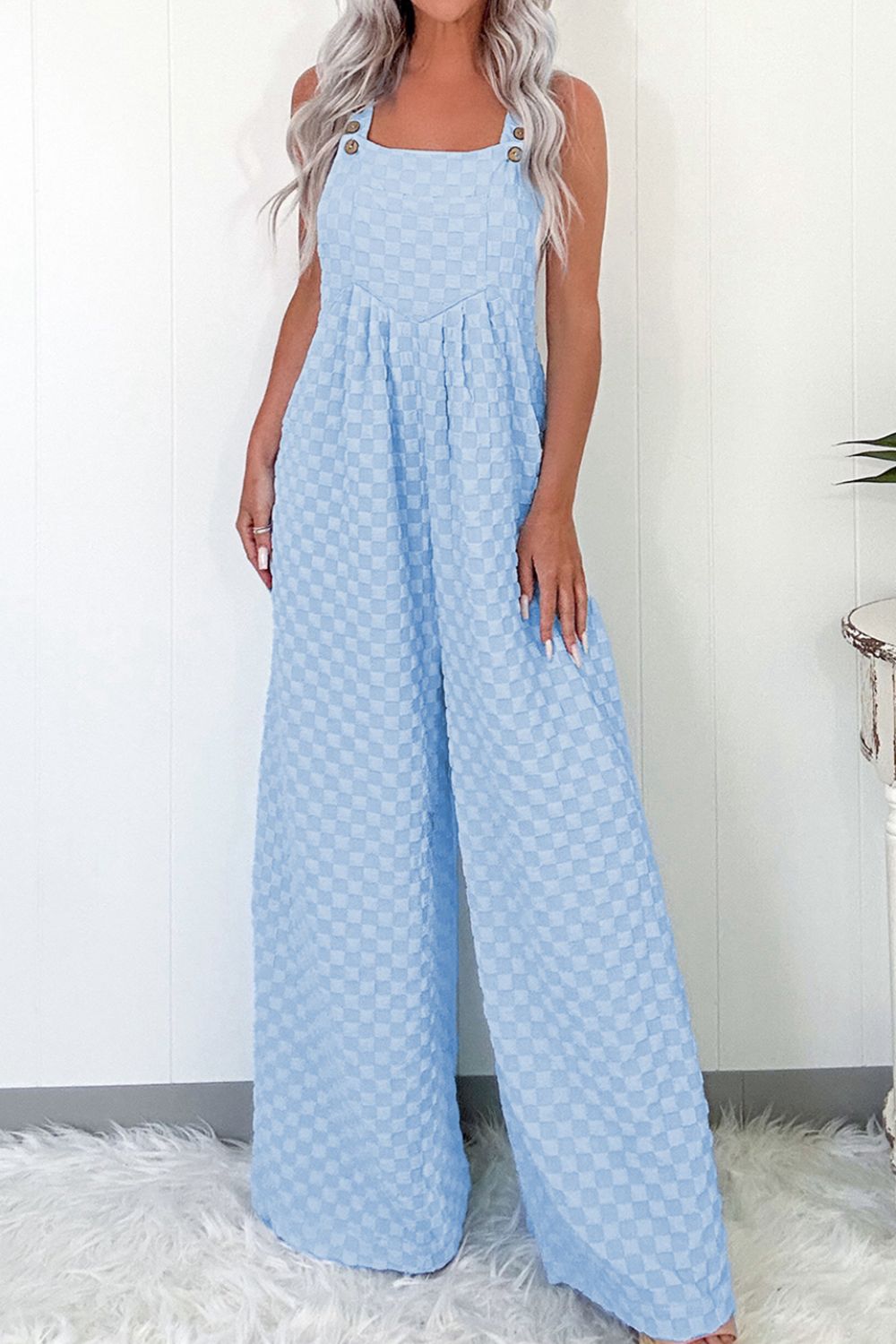 Upgrade your wardrobe with our Checkered Pocketed Wide Leg Overalls. These stylish and functional overalls feature a checkered design and spacious pockets, perfect for on-the-go convenience. Crafted with high-quality materials for both durability and comfort. Make a statement with these must-have overalls.