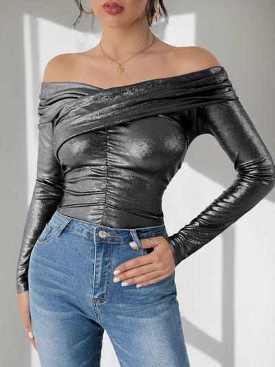 Elevate your style with our Off-Shoulder Bodysuit by Cruisin Essentials. Effortlessly elegant, the timeless off-shoulder neckline exudes sophistication. Crafted with premium materials, it offers a luxurious feel and perfect fit. A must-have for any fashion-forward wardrobe, indulge in the ultimate touch of sophistication.