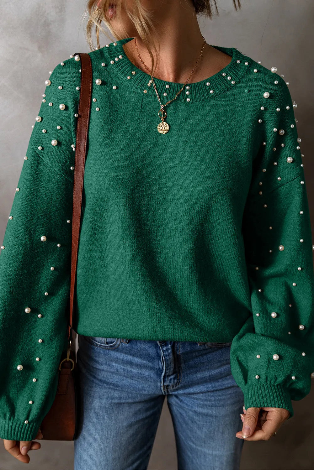 Elevate your style with our Cruisin Essentials Sweater! Adorned with elegant pearls on the round neck and sleeves, this cozy sweater adds sophistication to any look. Dare to be bold and stand out from the crowd with this statement piece.