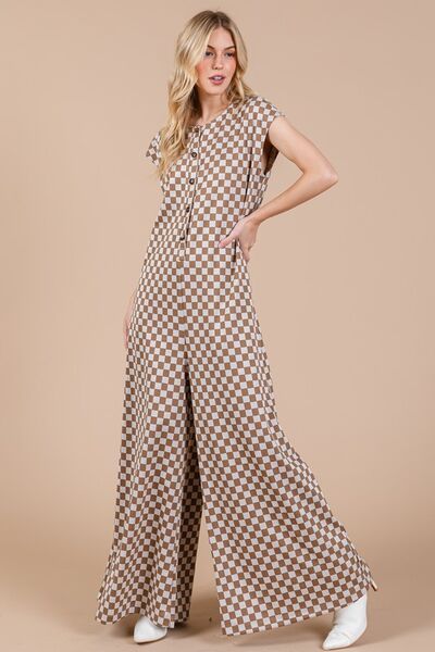 Unleash your bold and adventurous side with our Checkered Half Button Cap Sleeve Jumpsuit. Stand out from the crowd with this unique and daring jumpsuit, featuring a checkered print, cap sleeves, and a half button design. Perfect for those who love to take risks and make a statement.