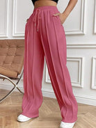 Discover the perfect combination of style and convenience with Cruisin Essentials expertly crafted Wide Leg Pants. With a drawstring waistband and spacious pockets, these pants offer both comfort and functionality. A must-have for any wardrobe, experience the ultimate comfort and convenience with our drawstring wide leg pants with pockets.