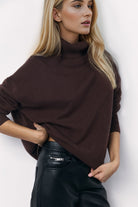 Stay warm and stylish this season with our Turtleneck Long Sleeve Dropped Shoulder Sweater. Expertly crafted for maximum comfort, the turtleneck design and dropped shoulder provide a trendy fit while the long sleeves offer added coverage. Elevate your wardrobe with this must-have piece.