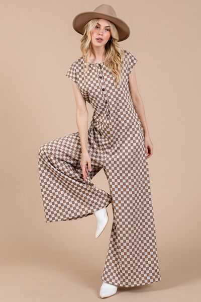 Unleash your fearless side with our Checkered Half Button Cap Sleeve Jumpsuit! Combining checkered print, cap sleeves, and a half button design, this daring jumpsuit is perfect for those who love to take risks and make a statement. Stand out from the crowd and embrace your adventurous spirit with this stylish piece.