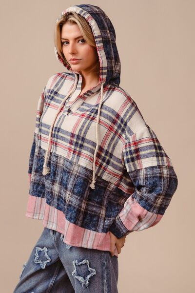 Be bold and fashionable in the Drop Shoulder Plaid Hoodie with Drawstring! The trendy plaid design adds an edgy touch, while the relaxed fit provided by the drop shoulders allows for comfort and style. Stay warm and customize the hoodie with drawstring detailing. Make a statement on cooler days with this functional yet trendy piece.