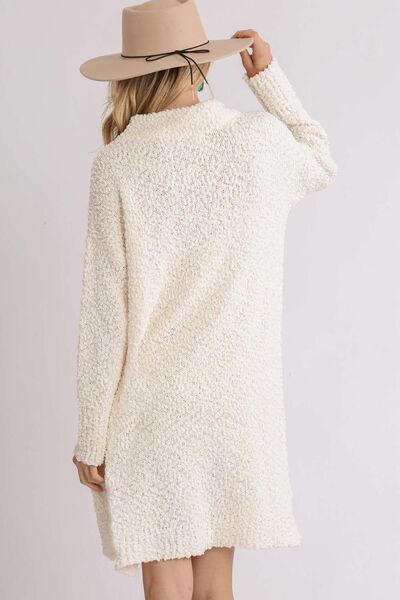 Wrap yourself in luxury with Umgee's High Low Boucle Sweater Dress. The full size fit and long sleeves provide both style and comfort, while the textured boucle fabric adds a touch of sophistication. Plus size options ensure a flattering fit for every body type. Elevate your wardrobe with this exclusive piece.