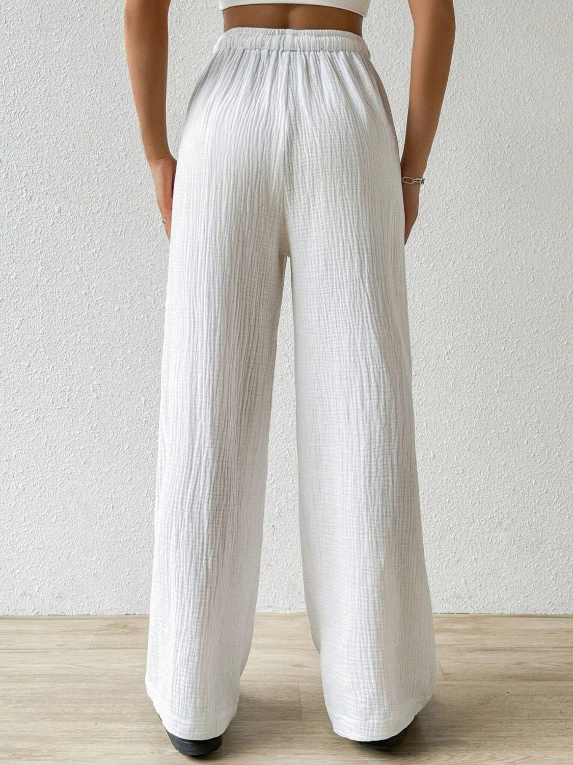 These white drawstring wide leg pants offered by Cruisin Essentials have a customizable fit with a drawstring waist, allowing for maximum comfort and freedom of movement. 