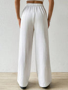 These white drawstring wide leg pants offered by Cruisin Essentials have a customizable fit with a drawstring waist, allowing for maximum comfort and freedom of movement. 